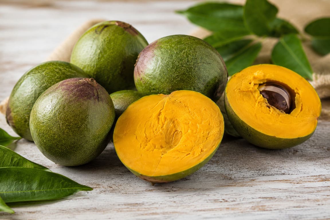 Whole and cut lucuma fruit